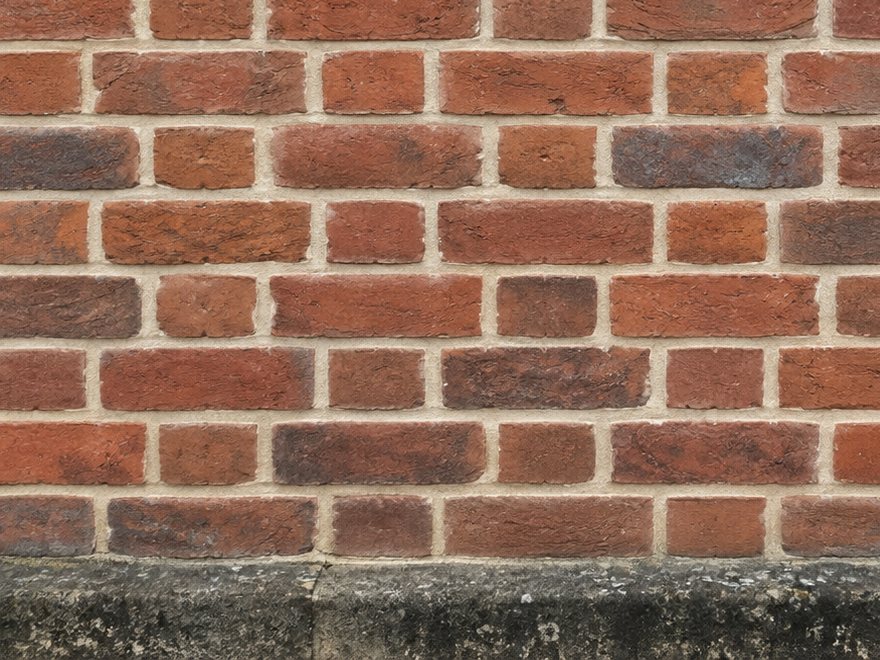 Old red brick wall repointed in soft buff lime mortar
